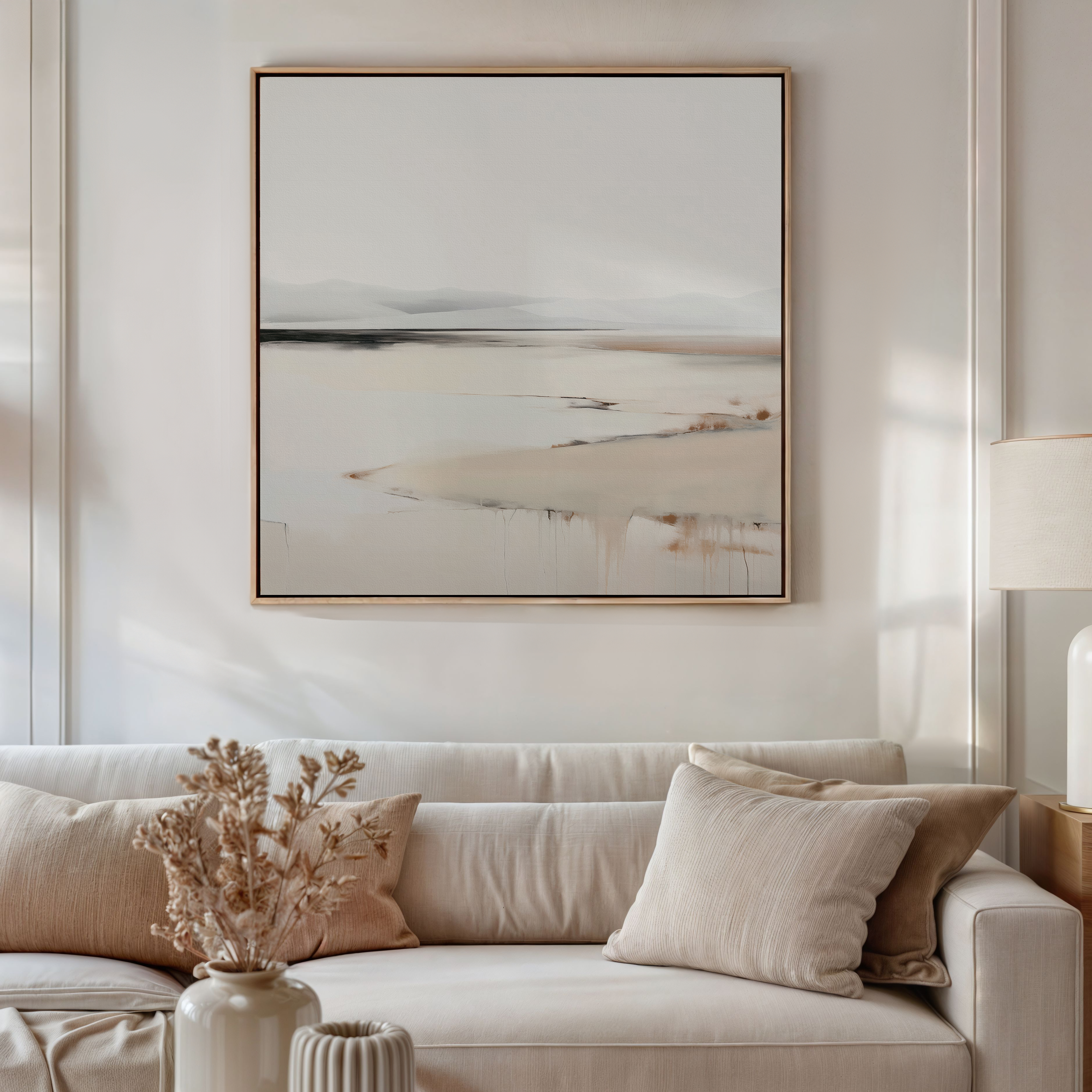 A neutral-toned living room with a beige sofa, cream and tan cushions, a dried flower arrangement in a ceramic vase, and the Quiet Valley Abstract Canvas Art above the sofa enhances the living room decor.