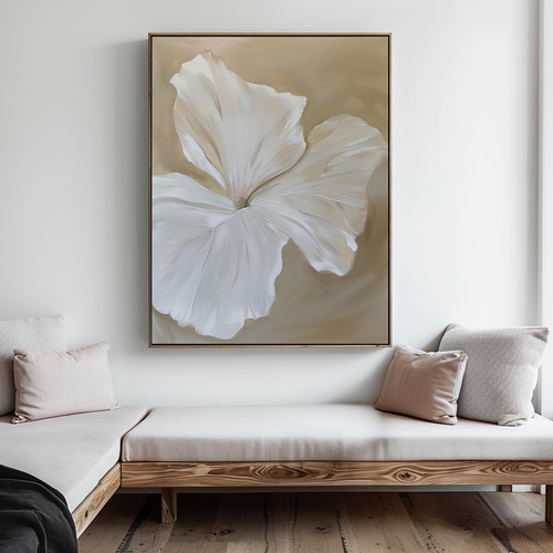 A minimalist living room with light wood furniture and neutral cushions features the Aqua Flora Abstract Canvas Art—a large painting of a white flower on a beige background—hung above the seating for an elegant decor touch.