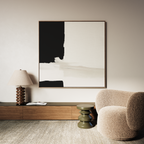 A minimalist living room features a beige armchair, small green side table, wooden cabinet, sculptural table lamp, open book, and Monochrome Harmony Abstract Canvas Art as striking modern wall decor above.