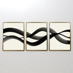 The Fluid Curves Set of 3 features abstract prints with black wavy brushstrokes flowing across a white background, creating striking modern wall art when displayed together.