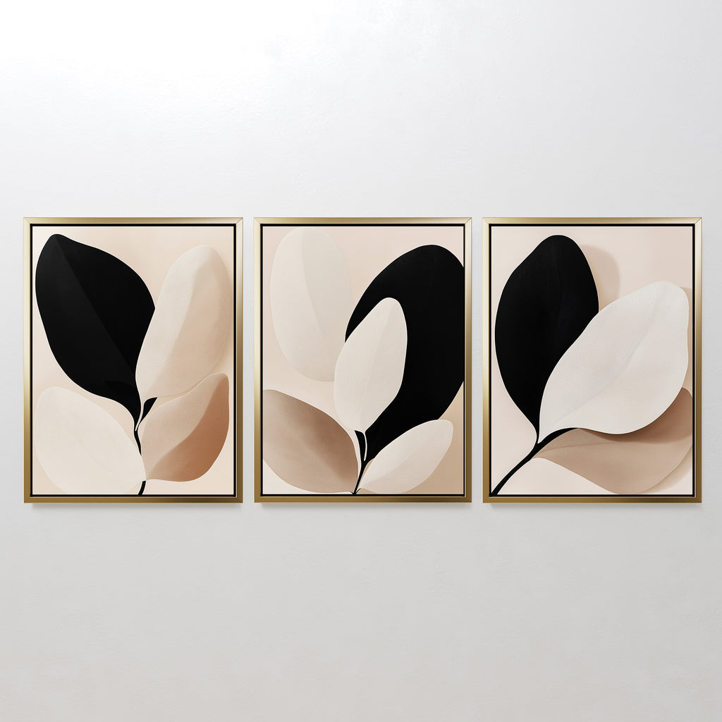 The Monochrome Flora Set of 3 features framed minimalist botanical prints in neutral black, beige, and cream tones—ideal for modern living room decor.