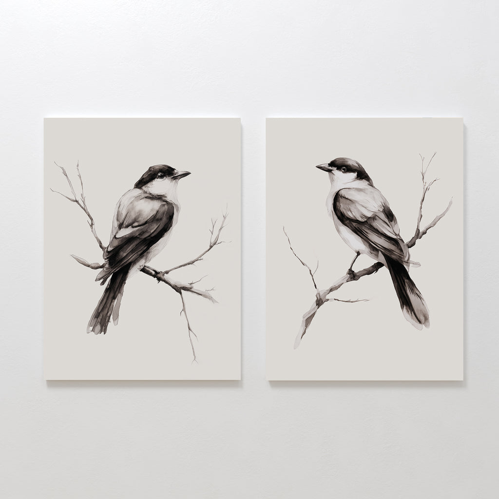The Still Perch Set of 2 features minimalist black and white bird prints, each perched on a branch and facing opposite ways on a light backdrop. This neutral-toned wall art brings a touch of Nordic Park style to any space.