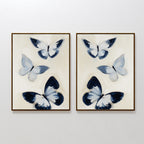 The Midnight Wings Set of 2 features framed wall art with blue and white butterflies and dark accents, hung side by side on a white wall for modern, Nordic Park-inspired decor.
