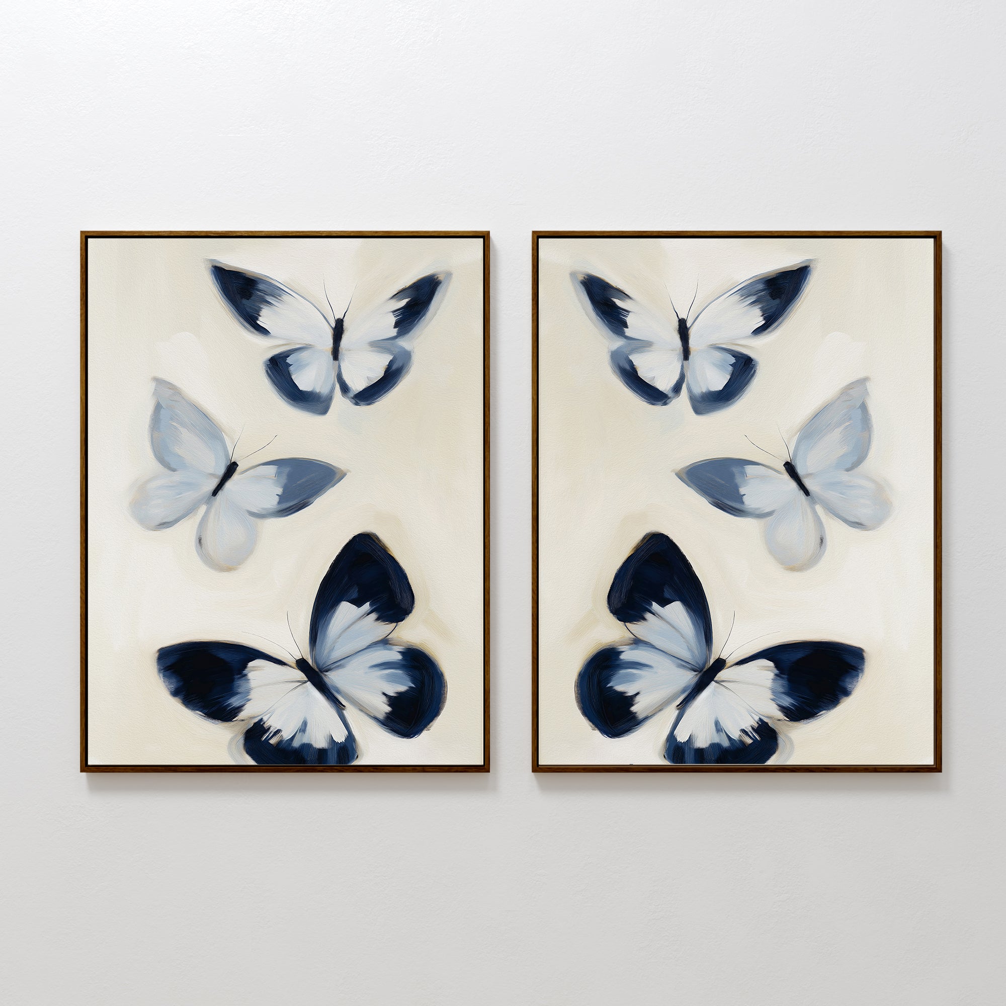 The Midnight Wings Set of 2 features framed wall art with blue and white butterflies and dark accents, hung side by side on a white wall for modern, Nordic Park-inspired decor.