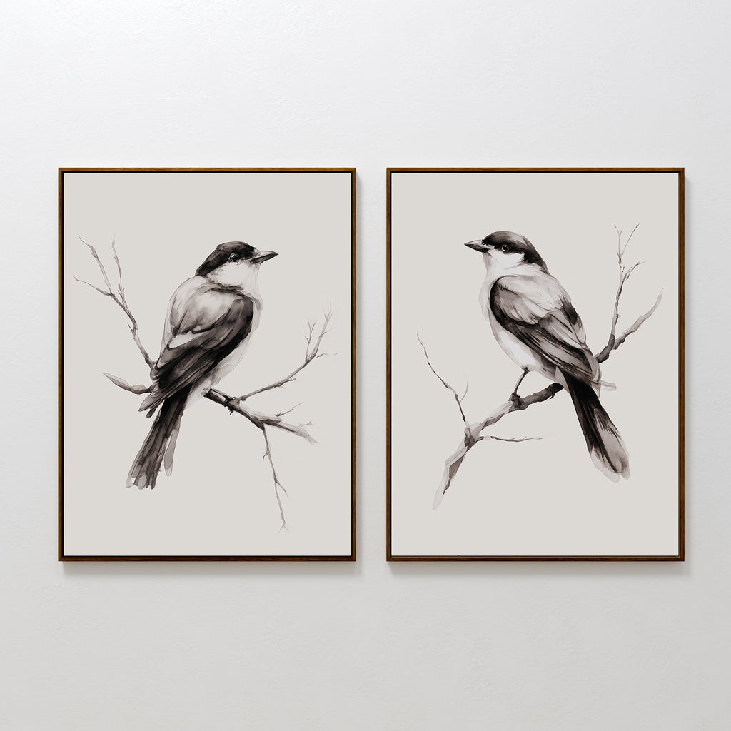 The Still Perch Set of 2 features framed black-and-white bird prints, each showing a bird on a branch facing opposite directions—an elegant Nordic Park accent for your neutral-toned wall art collection.