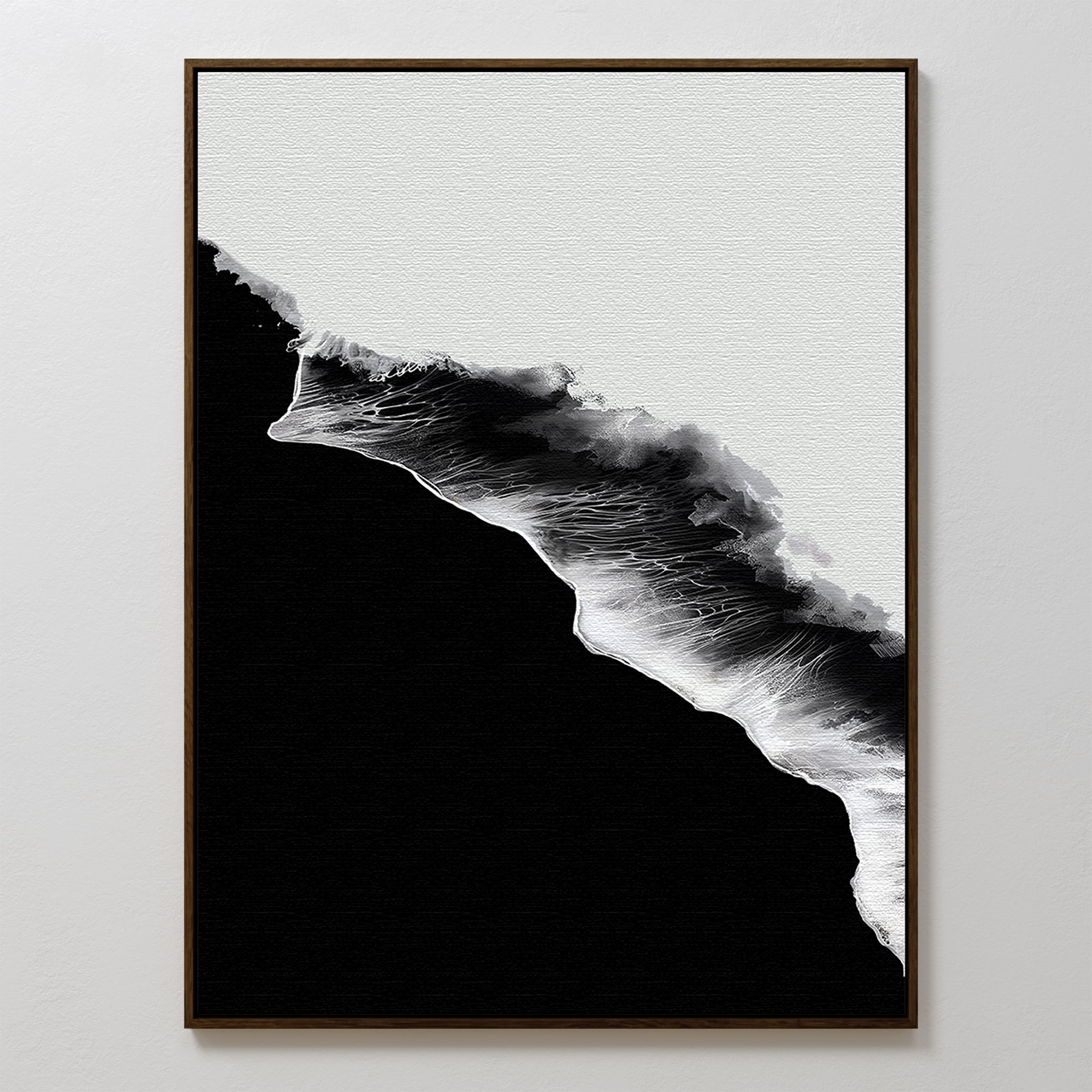 Black Ocean Abstract Canvas Art features a minimalist black and white design of ocean waves with textured white foam on a deep black background. This large wall art comes framed in a thin, dark frame.