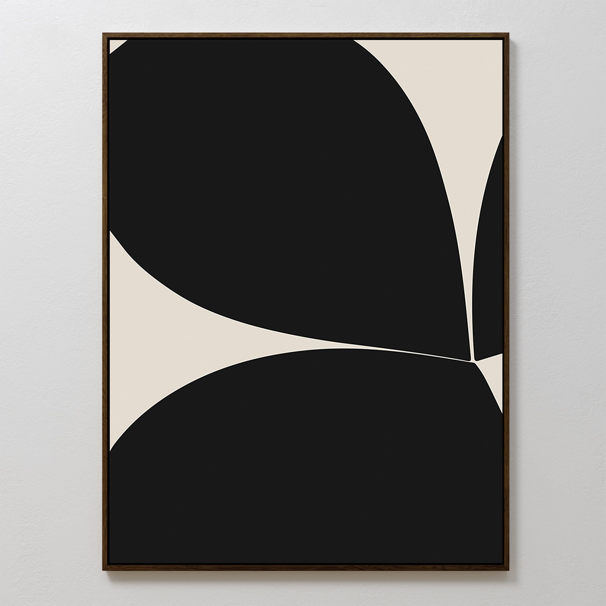 The Black Botanical Abstract Canvas Art features large curved black shapes intersecting on a white background with a slim dark frame, creating bold, organic forms and striking contrast for a minimalist, contemporary look.