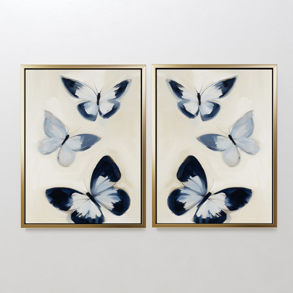 The Midnight Wings Set of 2 features framed paintings of abstract blue, black, and white butterflies on a light background—ideal as modern wall decor or striking butterfly art for your space.