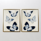 The Midnight Wings Set of 2 features framed paintings of abstract blue, black, and white butterflies on a light background—ideal as modern wall decor or striking butterfly art for your space.