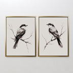 The Still Perch Set of 2 features framed black-and-white bird art prints, each bird facing the center on bare branches. Mounted side by side, theyre ideal for Nordic Park-inspired spaces or those who love neutral wall art.