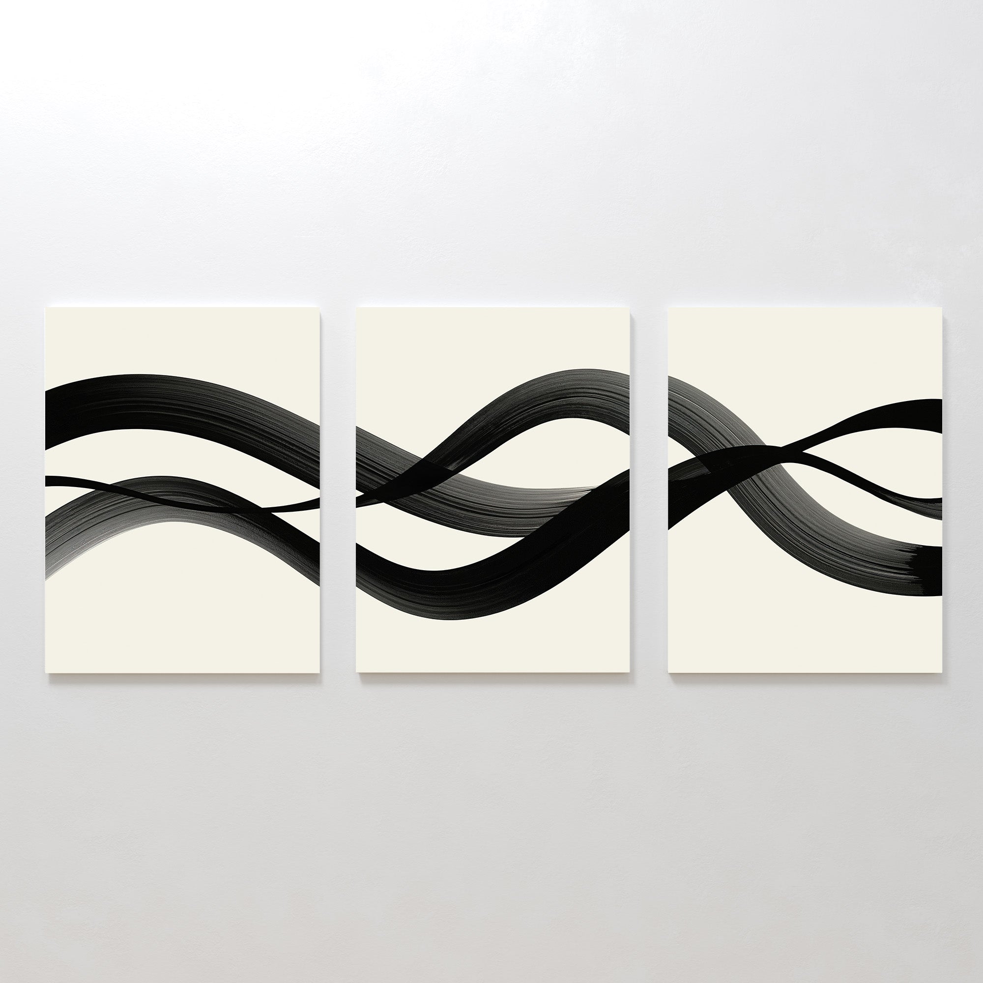 The Fluid Curves Set of 3 features minimalist canvases with continuous black brushstrokes on light backgrounds, creating a serene, abstract wall art trio with wave-like Nordic-inspired patterns.