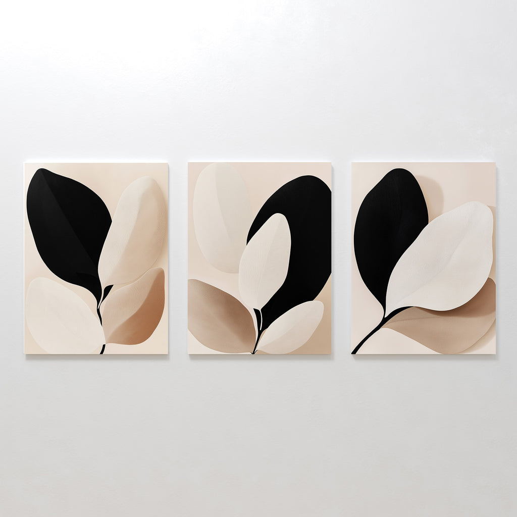 The Monochrome Flora Set of 3 features minimalist botanical prints with abstract leaf shapes in black, beige, and cream—perfect botanical wall art for modern living room decor.