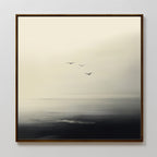 The Above the Calm Canvas Art features three birds flying over a misty seascape in soft monochrome, making it perfect minimalist wall art to bring a serene and tranquil feel to your bedroom decor.