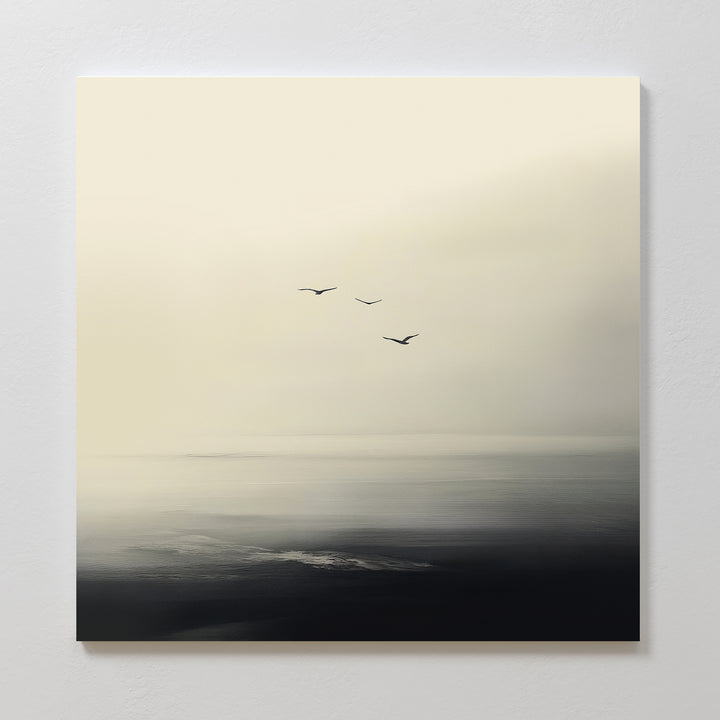 Above the Calm Canvas Art features a serene seascape in soft, muted tones with three birds flying above tranquil, dark water beneath a pale sky—ideal for large living room or bedroom decor.