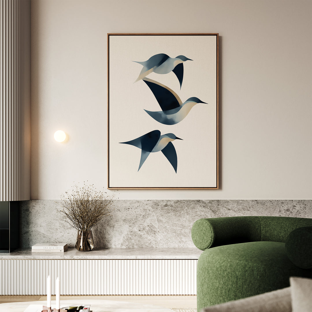A modern living room with a green sofa, a low marble shelf, and Abstract Birds in Motion Canvas Art—a minimalist piece of three blue birds in flight. A vase with dried branches on the shelf completes the Nordic Park-inspired decor.
