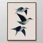 Abstract Birds in Motion Canvas Art features three stylized birds in flight, crafted with smooth blue and beige shapes on a light background and set in a simple dark frame for a modern Nordic touch.