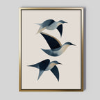 Abstract Birds in Motion Canvas Art features three blue and beige abstract birds flying on a light backdrop, set in a slim gold frame. This minimalist wall print brings Nordic Park-inspired elegance to any space.