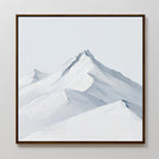 The Alpine Ascent Abstract Canvas Art showcases snow-capped mountain peaks and soft blue-gray shadows against a pale sky. Framed in brown, this minimalist wall art adds serene elegance to any living room decor.