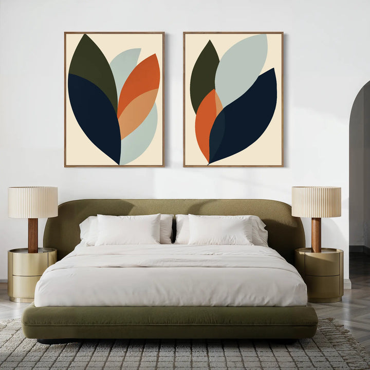 A modern bedroom with an olive-green bed, white bedding, and two beige nightstands with matching lamps. Above the bed, the Autumn Layers Set of 2 adds a touch of modern style with abstract green, orange, navy, and light blue art.