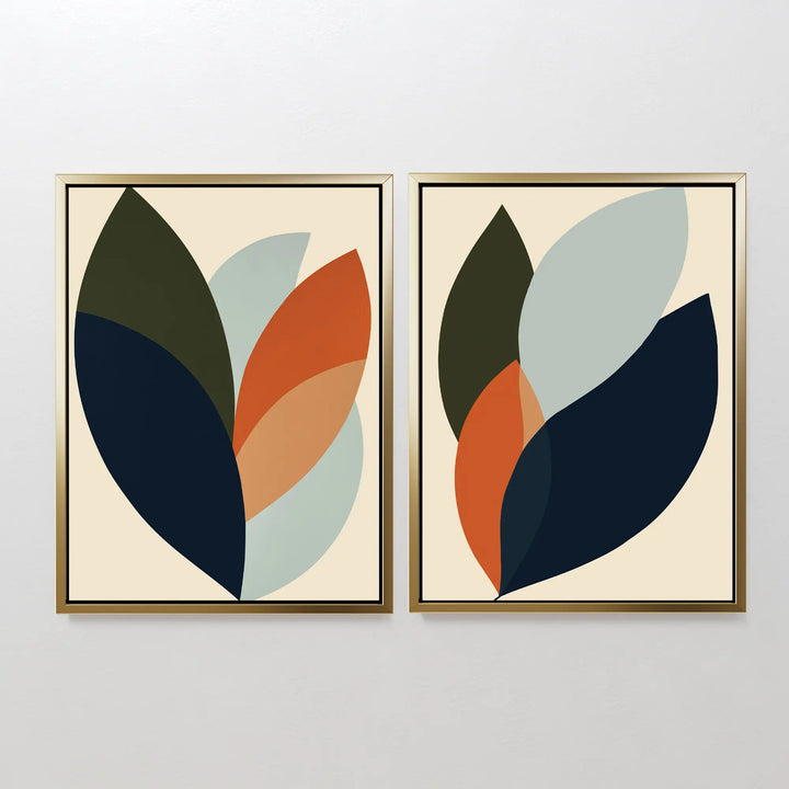 The Autumn Layers Set of 2 includes framed abstract wall art prints with overlapping leaf shapes in navy, olive, orange, and light blue on beige—ideal as modern living room decor or side-by-side wall art.