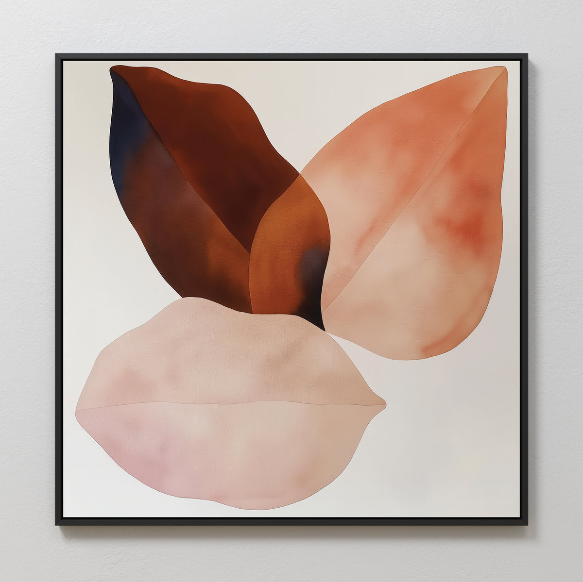 The Autumn Petals Canvas Art features three overlapping abstract leaf shapes in brown, peach, and blush pink on a white background, finished with a sleek black frame.