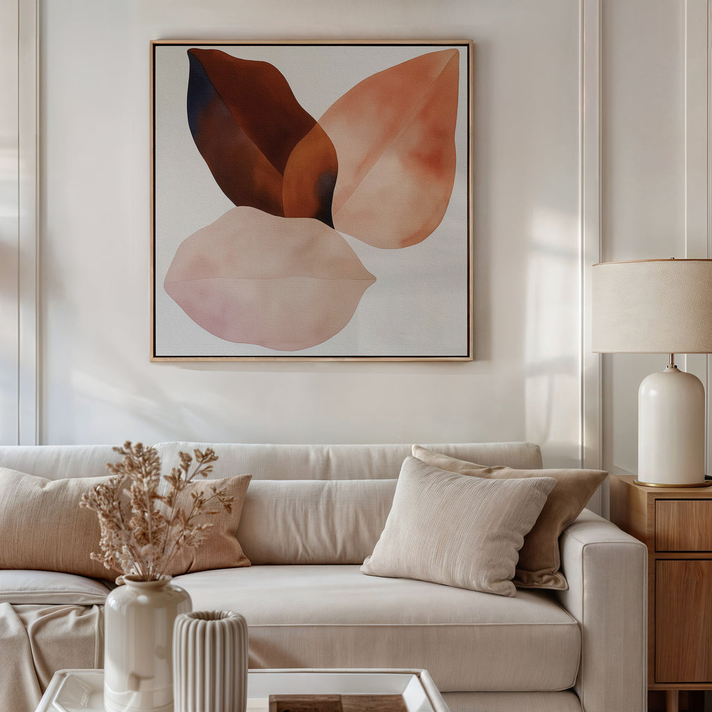 A modern living room features a beige sofa, neutral pillows, white table, dried flowers in a vase, and the Autumn Petals Canvas Art in soft brown and pink tones above the sofa. A table lamp rests on a wooden side table.