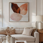 A modern living room features a beige sofa, neutral pillows, white table, dried flowers in a vase, and the Autumn Petals Canvas Art in soft brown and pink tones above the sofa. A table lamp rests on a wooden side table.