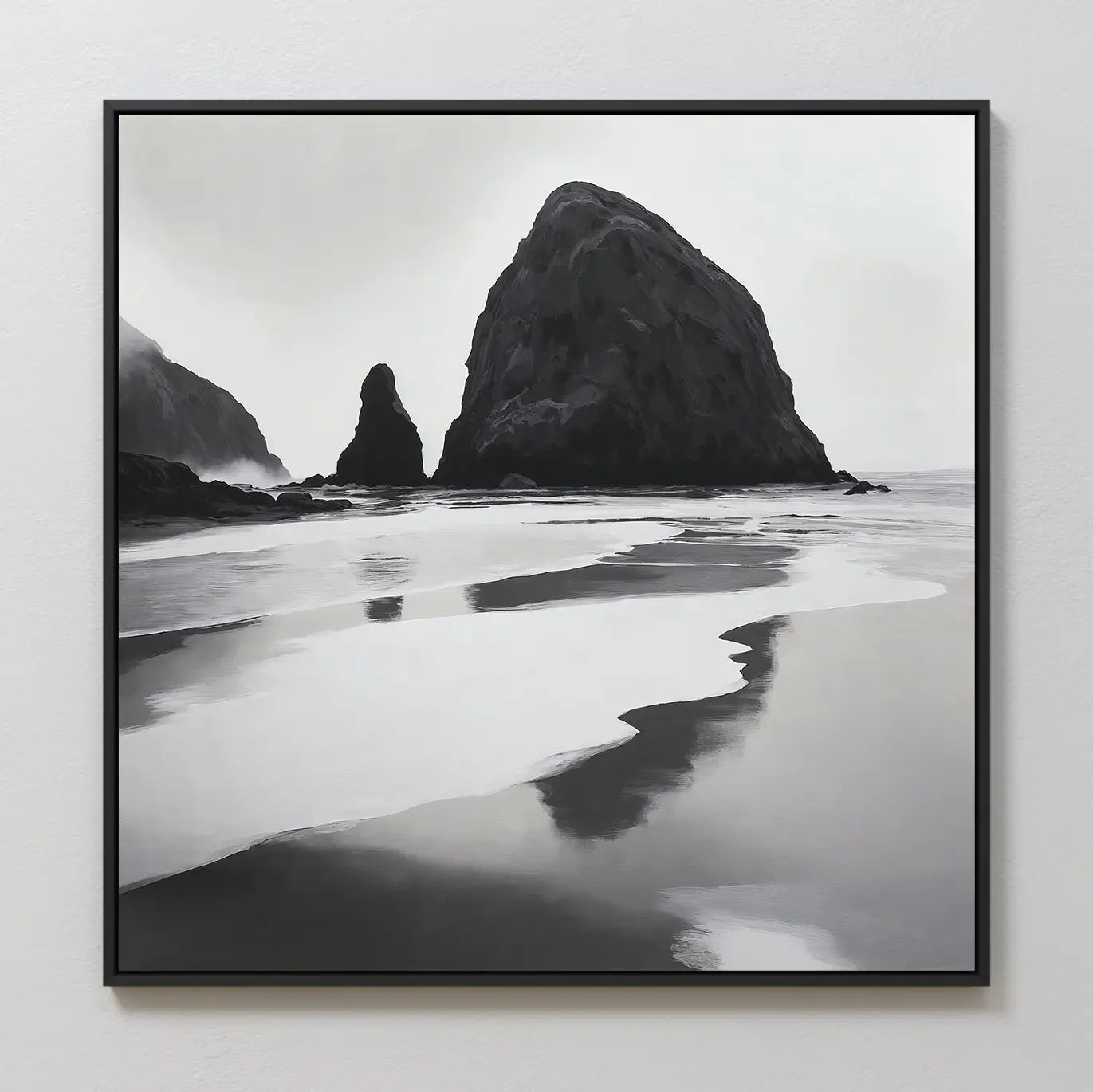 Basalt Beach Canvas Art: a black and white framed photo featuring large rocky sea stacks and reflective wet sand, creating a calm, misty scene—ideal minimalist wall décor for coastal homes.