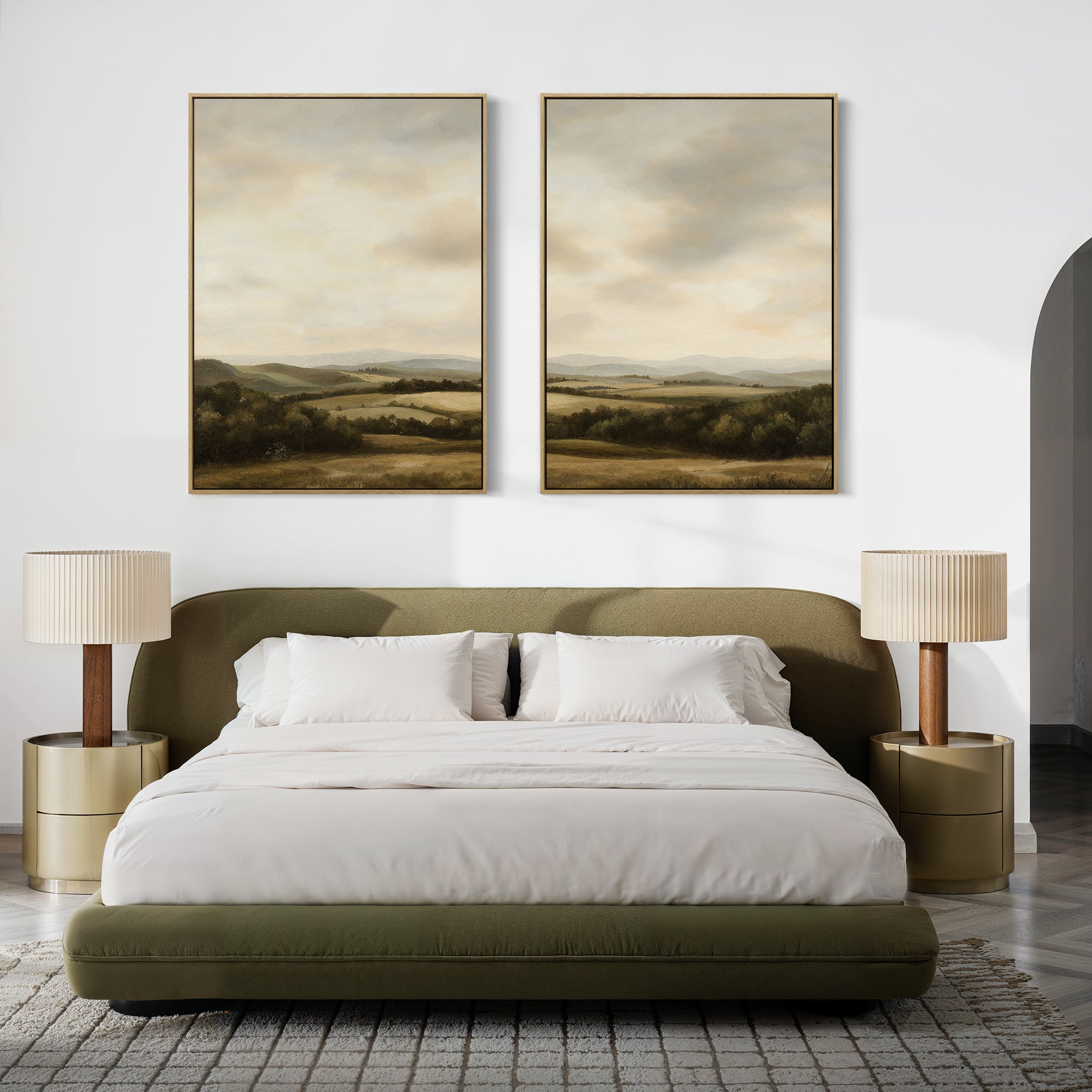 A modern bedroom with an olive green bed, white bedding, two beige nightstands with matching lamps, and the Beneath The Clouds Set of 2 landscape canvas art hanging above the bed on a white wall.