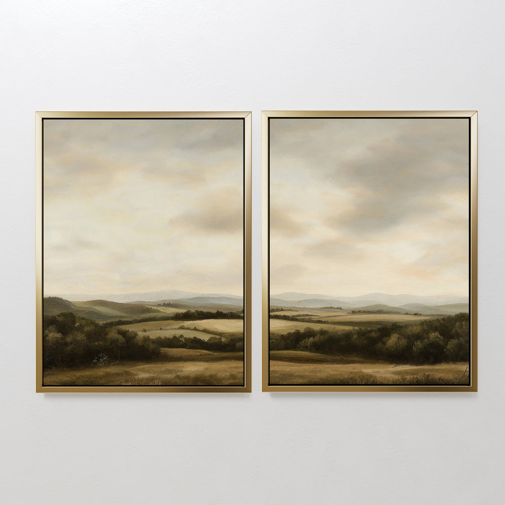 The Beneath The Clouds Set of 2 features framed landscape paintings of rolling green hills under a cloudy sky, with soft, muted colors. This minimalist wall art canvas set adds a serene, natural touch to any space.