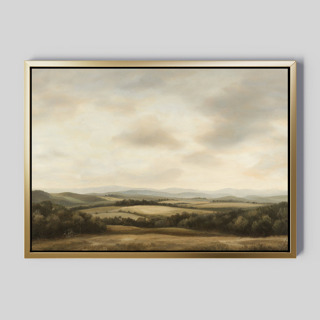 Beneath The Clouds Canvas Art is a large framed wall piece featuring rolling hills and fields under a cloudy sky in soft green, brown, and beige tones, set against a gray background for a minimalist look.