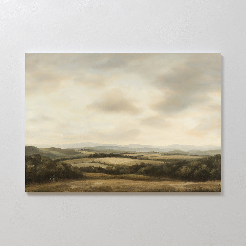 Beneath The Clouds Canvas Art features rolling hills, scattered trees, and fields beneath a cloudy sky in soft earth tones—ideal minimalist wall decor to add calm elegance to your space.