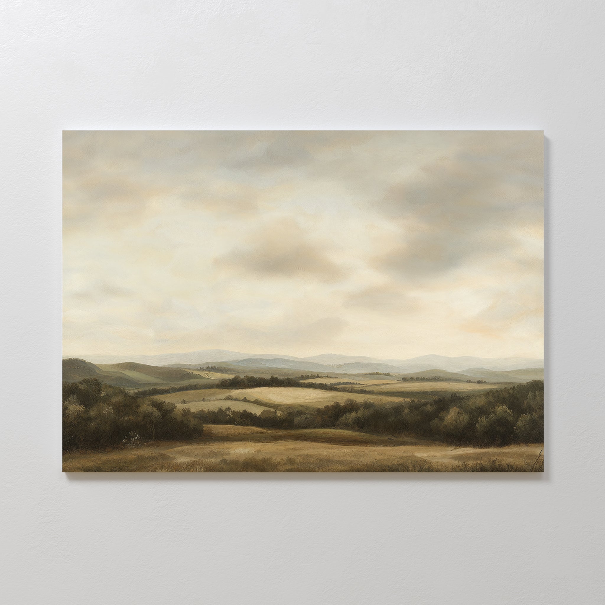 Beneath The Clouds Canvas Art features rolling hills, scattered trees, and fields beneath a cloudy sky in soft earth tones—ideal minimalist wall decor to add calm elegance to your space.