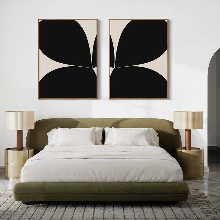 A modern bedroom with an olive green upholstered bed, neutral bedding, two round nightstands with matching lamps, and the Minimal Petal Set of 2 minimalist wall art featuring abstract black shapes above the bed.