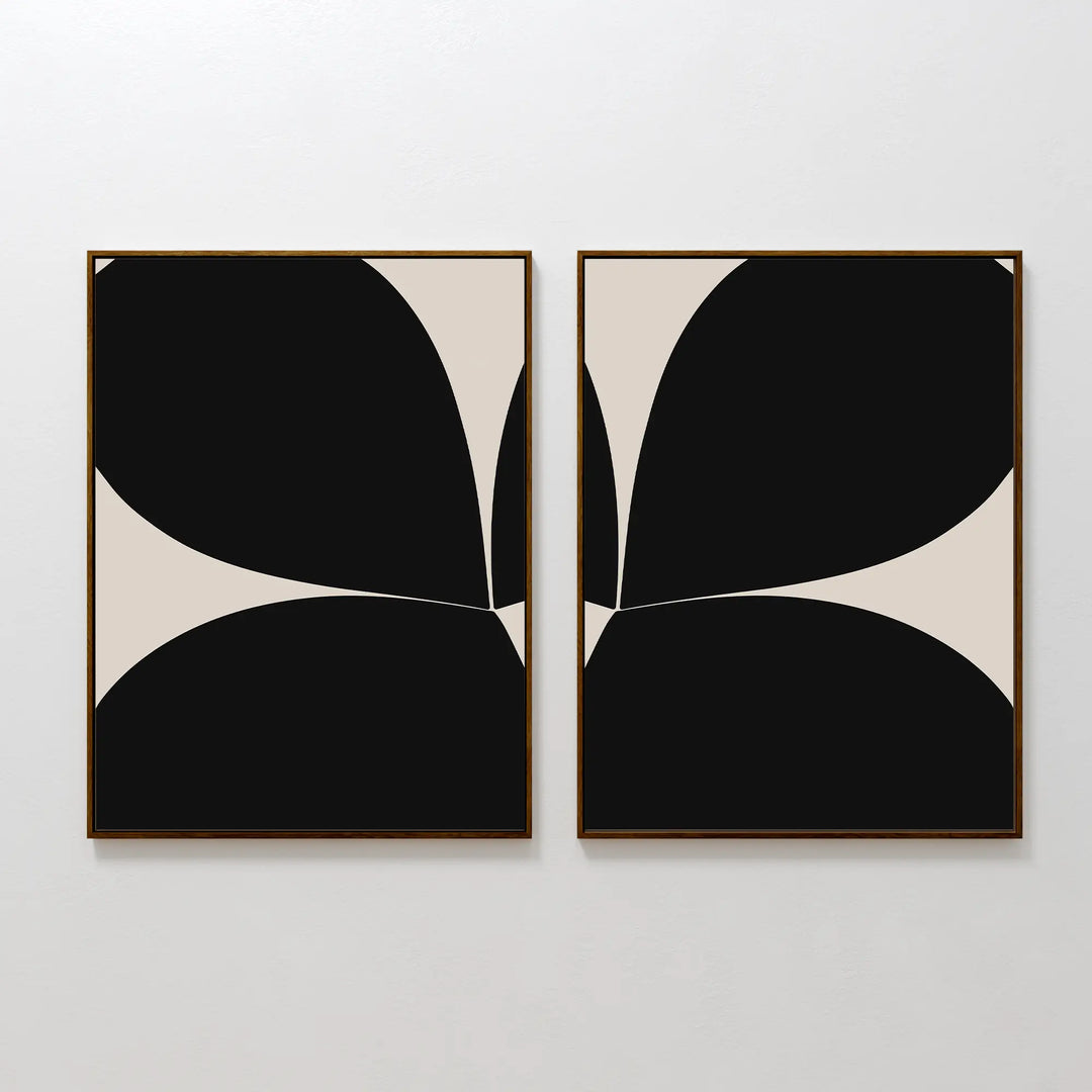 The Minimal Petal Set of 2 features framed abstract art prints with bold black shapes on cream backgrounds, arranged symmetrically for a mirrored look—ideal for adding a modern touch to your wall decor.