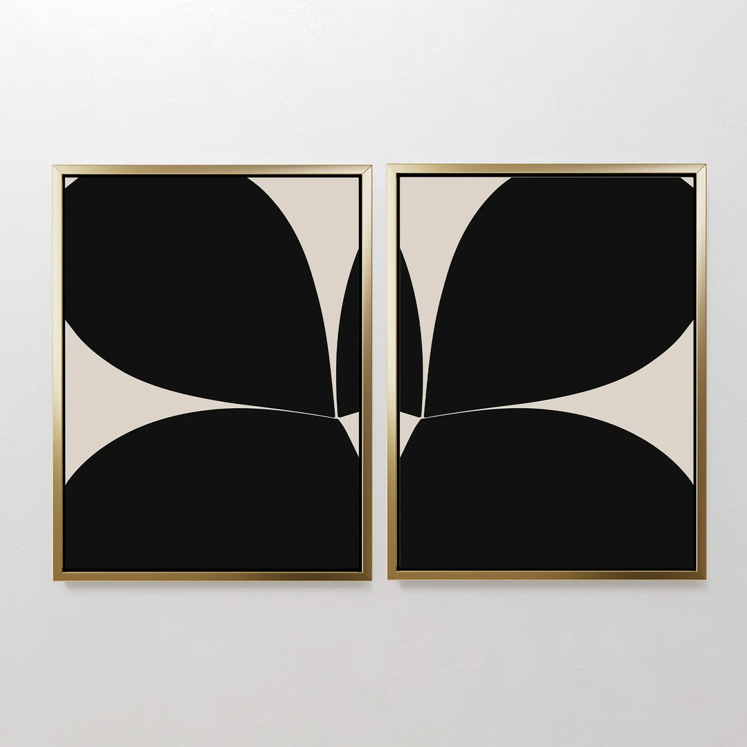 The Minimal Petal Set of 2 features minimalist framed prints with abstract black and beige shapes in bold, mirrored patterns—displayed side by side as modern wall decor on a plain white wall.