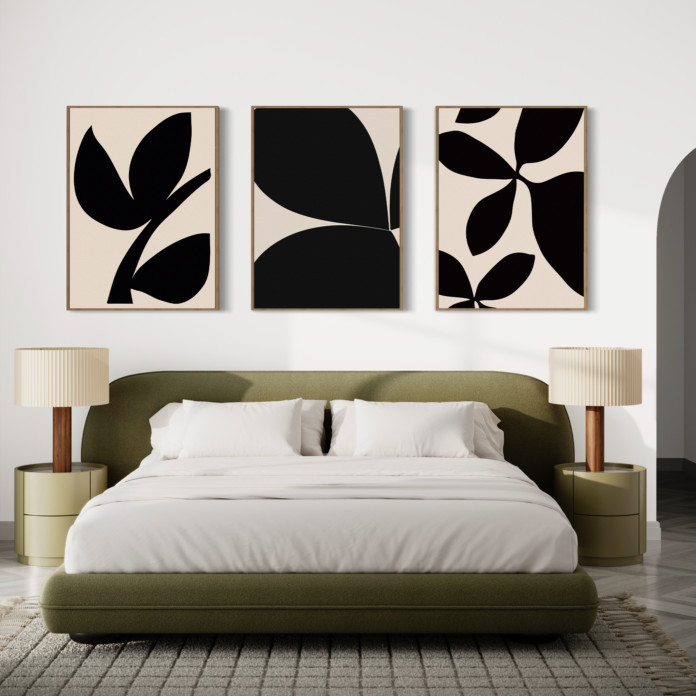 A modern bedroom features an olive green bed with white bedding, two beige nightstands with lamps, and the Black Botanical Set of 3—minimalist black and white abstract leaf prints inspired by Nordic Park—displayed above the bed.