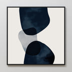 Blue Currents Canvas Art features minimalist abstract wall art with three overlapping, irregular navy and translucent shapes on a light beige background, finished with a simple black frame.