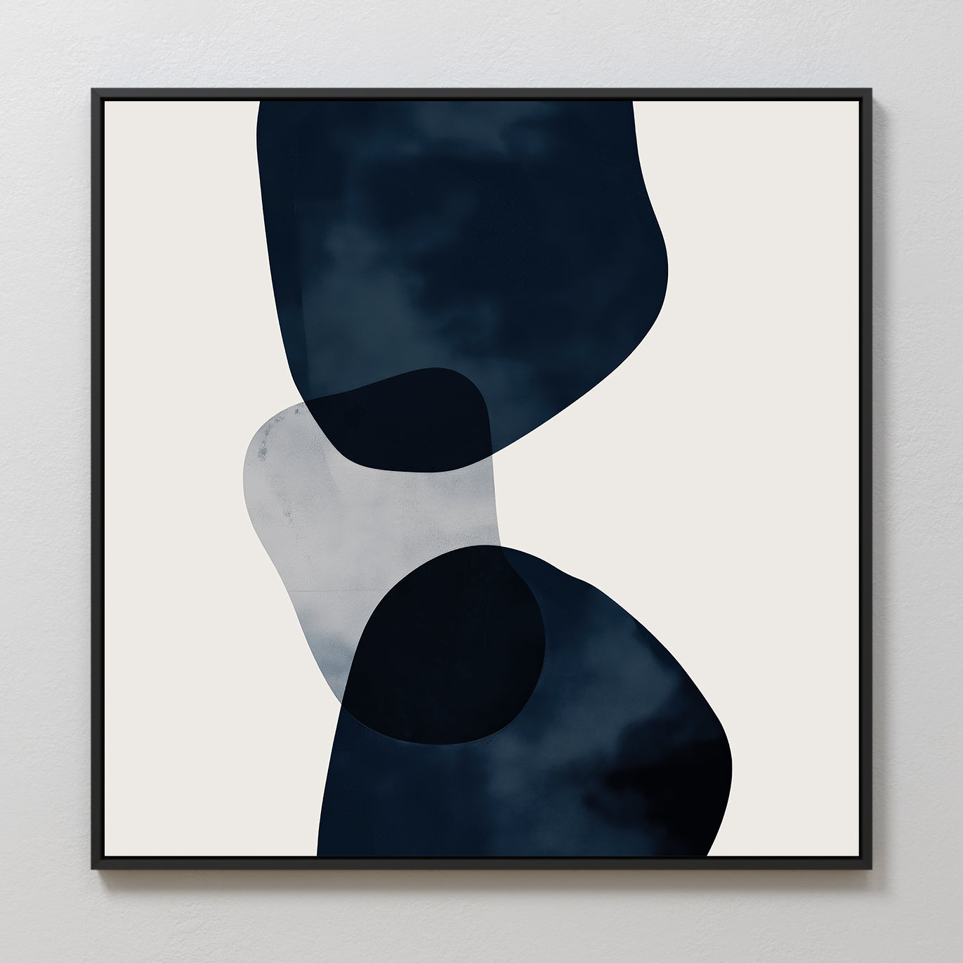 Blue Currents Canvas Art features minimalist abstract wall art with three overlapping, irregular navy and translucent shapes on a light beige background, finished with a simple black frame.