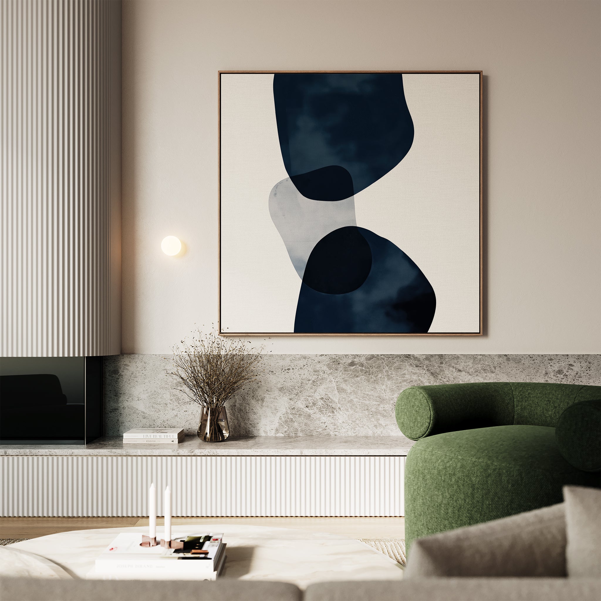 A modern living room with a green curved armchair, marble accents, a minimalist coffee table, dried branch vase, and the Blue Currents Canvas Art featuring striking abstract dark and light shapes on the wall.