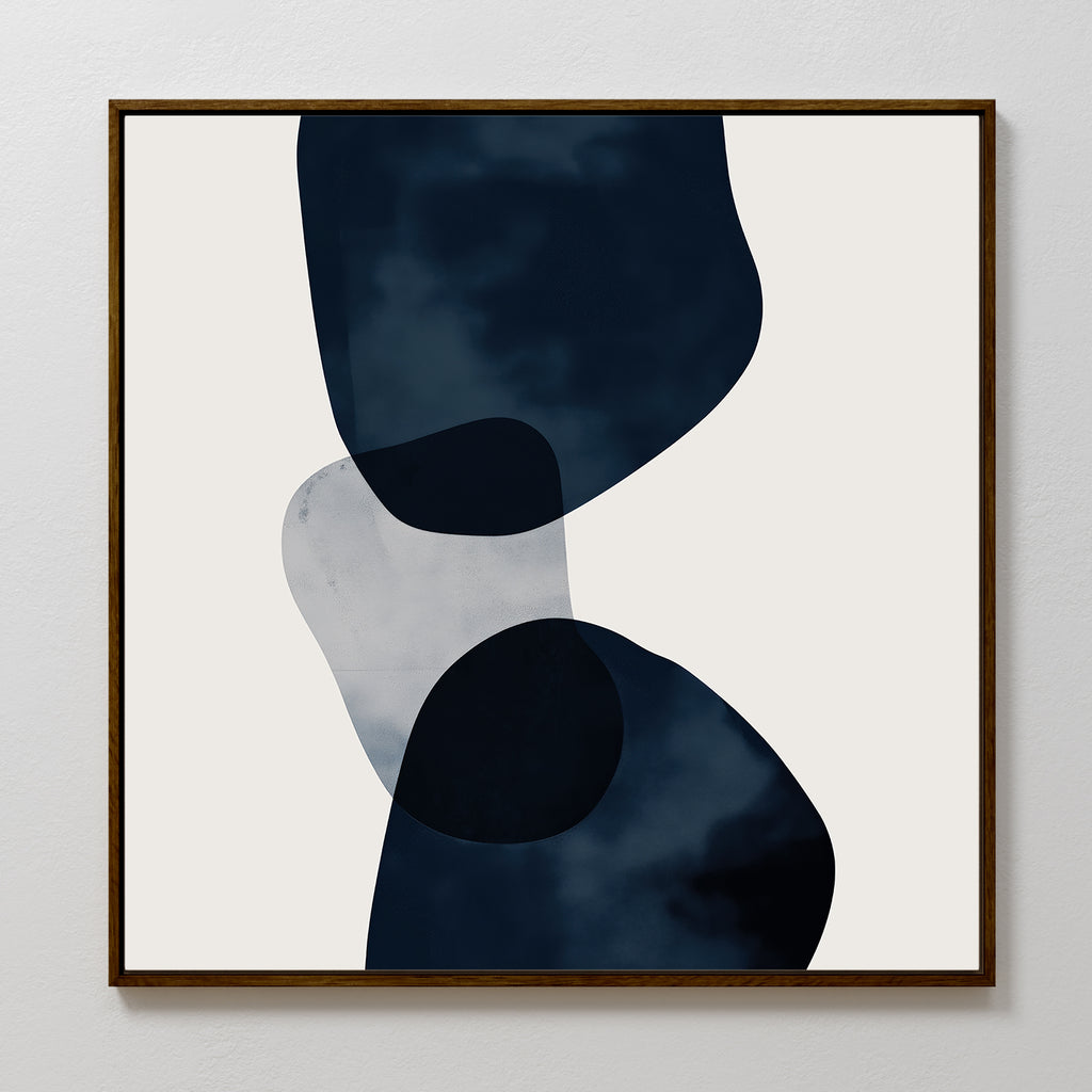 Blue Currents Canvas Art features three overlapping, irregular shapes in dark blue and gray with soft, organic edges on a light background, framed in simple wood for a refined minimalist and abstract wall art style.
