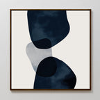 Blue Currents Canvas Art features three overlapping, irregular shapes in dark blue and gray with soft, organic edges on a light background, framed in simple wood for a refined minimalist and abstract wall art style.