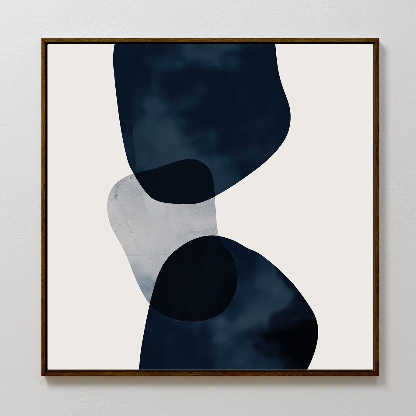Blue Currents Canvas Art features three overlapping, irregular shapes in dark blue and gray with soft, organic edges on a light background, framed in simple wood for a refined minimalist and abstract wall art style.