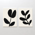 The Black Leaf Set of 2 features minimalist prints with bold black abstract plant silhouettes, each showing a stylized stem with rounded leaves—perfect botanical wall art for modern decor.