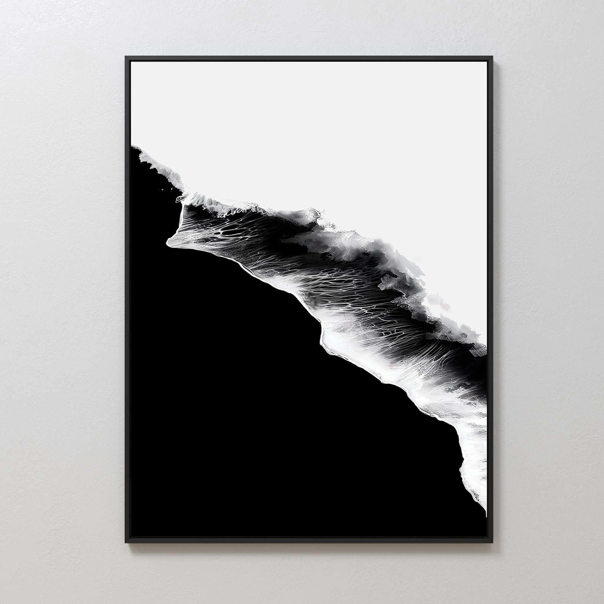 Black Ocean Abstract Canvas Art: A framed minimalist wall piece with a jagged, diagonal black-and-white design. The white area looks like crashing waves on a bold black background, displayed on a plain light-colored wall.