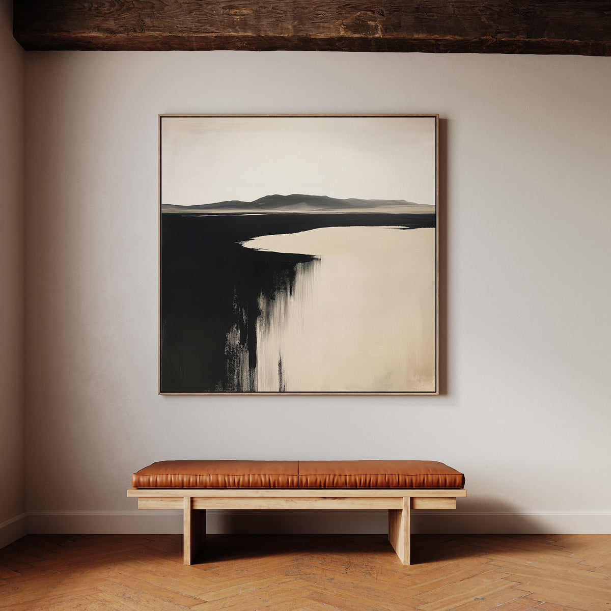 A minimalist room with light walls displays the Black Shore Canvas Art—a large neutral abstract—above a wooden bench with a brown leather cushion, all set on a herringbone wood floor.