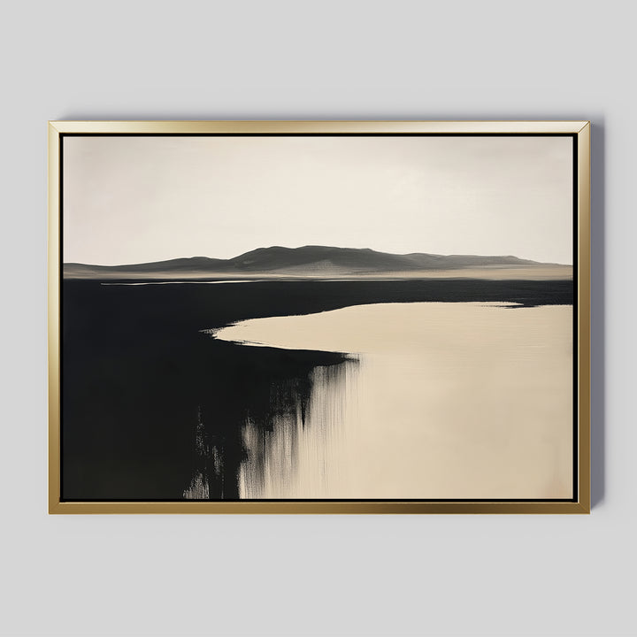 The Black Shore Canvas Art – Horizontal features a minimalist landscape with distant mountains and calm water in contrasting shades, framed in gold on a gray background—ideal as large wall art for modern living rooms.