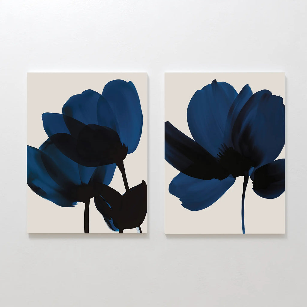The Bloom Set of 2 features minimalist canvas art with abstract dark blue flowers and black stems on beige backgrounds, adding Nordic Park-inspired elegance and contemporary style to any room.