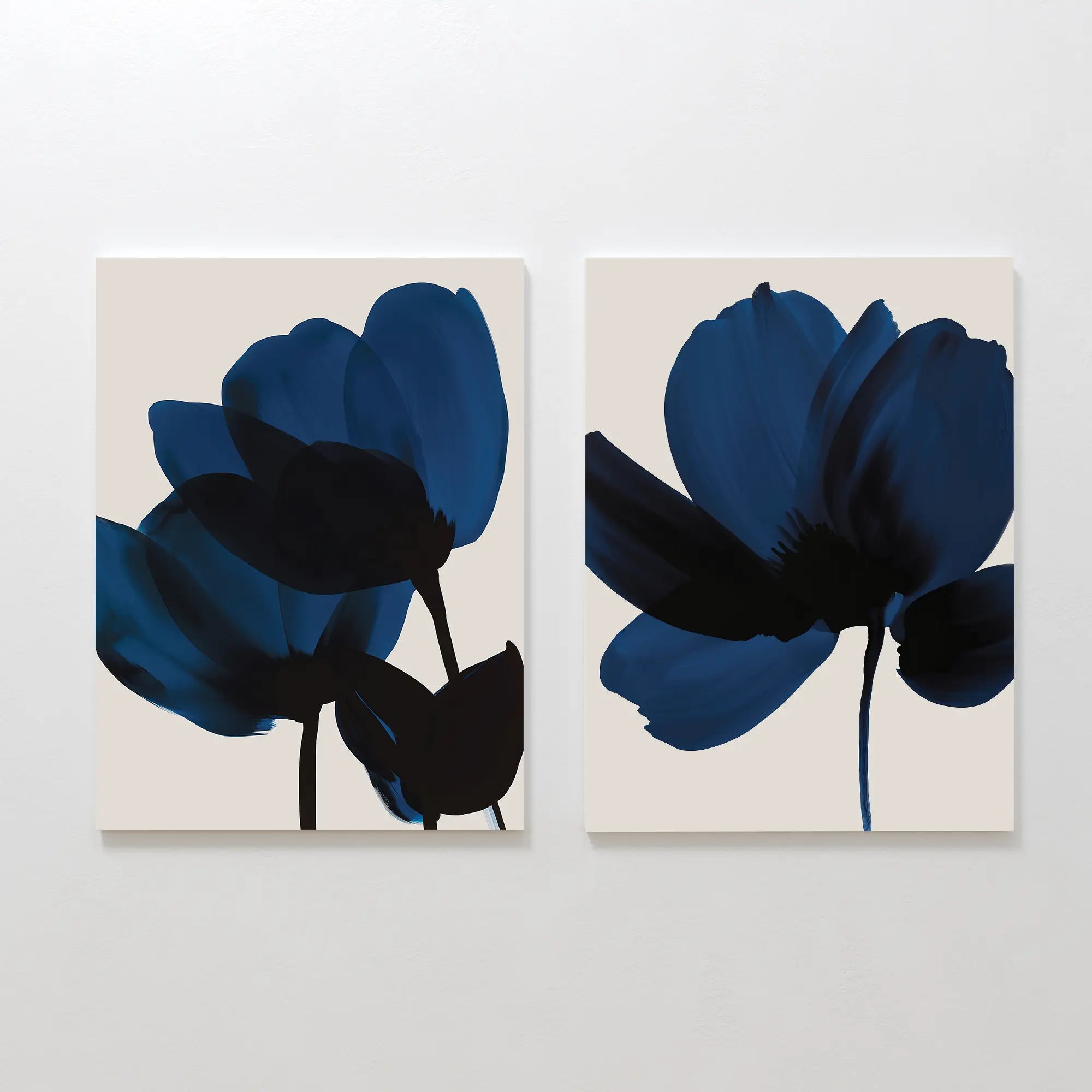 The Bloom Set of 2 features minimalist canvas art with abstract dark blue flowers and black stems on beige backgrounds, adding Nordic Park-inspired elegance and contemporary style to any room.