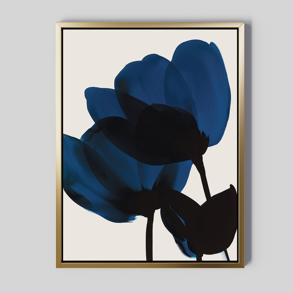 Bloom Abstract Canvas Art features two abstract blue and black flowers with bold brushstrokes, set against a light background and framed in a slim gold frame—ideal for modern living room decor.